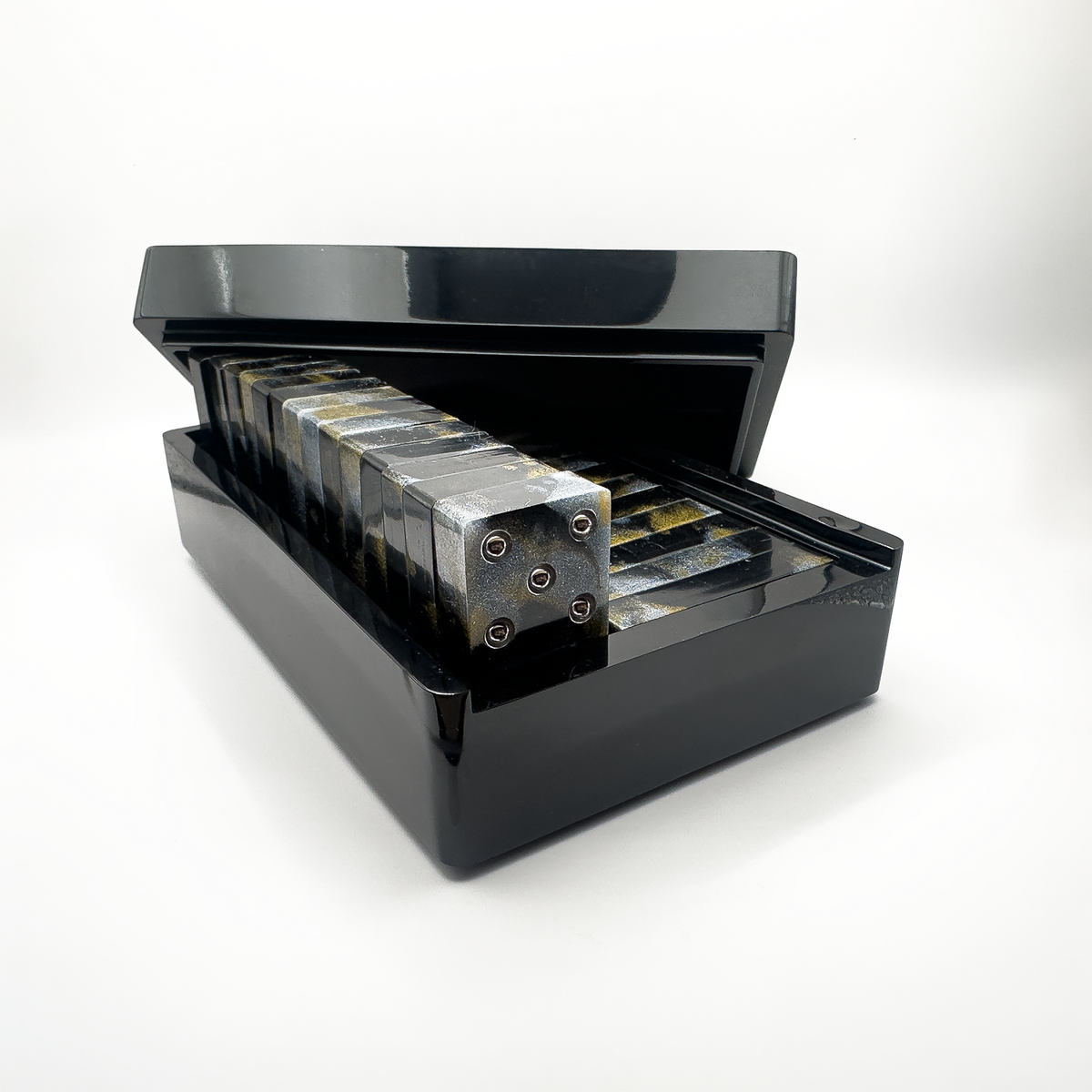 Pyrite black-and-gold hand-cast resin domino set with matching Millennium Vault case — Millennium Casts