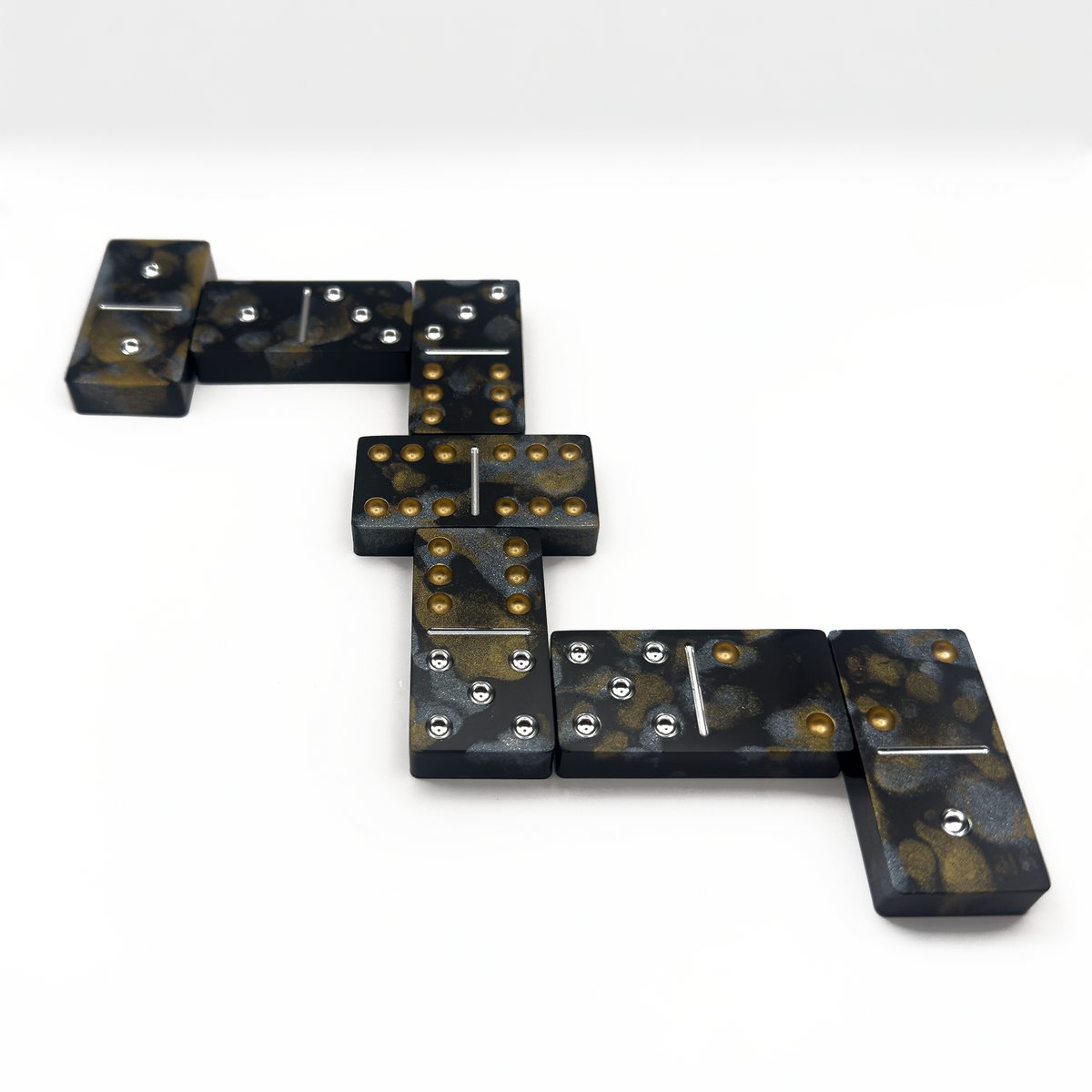Pyrite resin dominoes stacked in Millennium Vault case — Millennium Casts